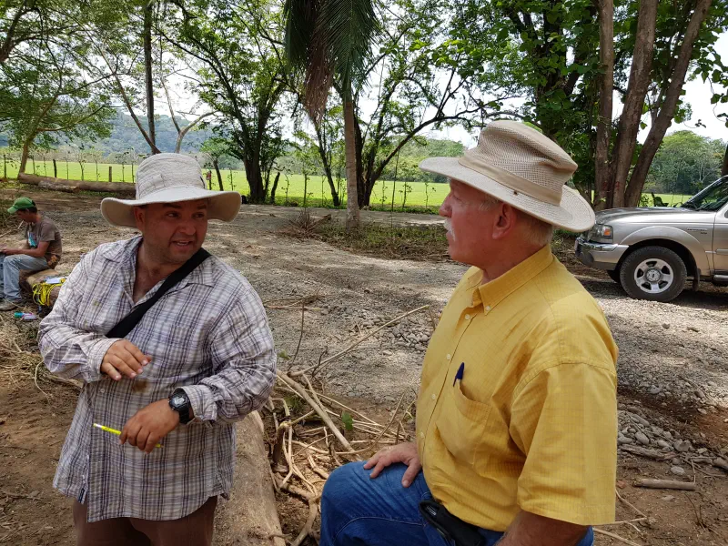 A photograph of a colleague of Easterwoods on the left talking with a farmer on the right