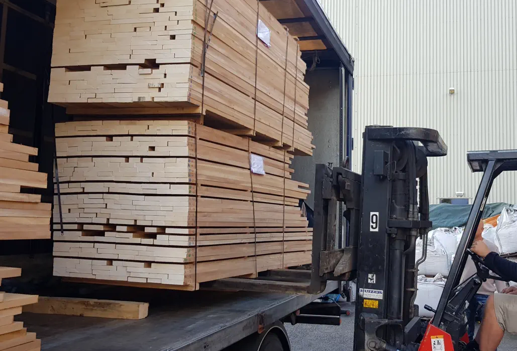 Stacks of sawn teak lifted out of a truck