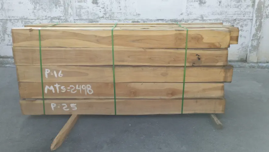 A photograph of stacks of rough sawn squares laying outside