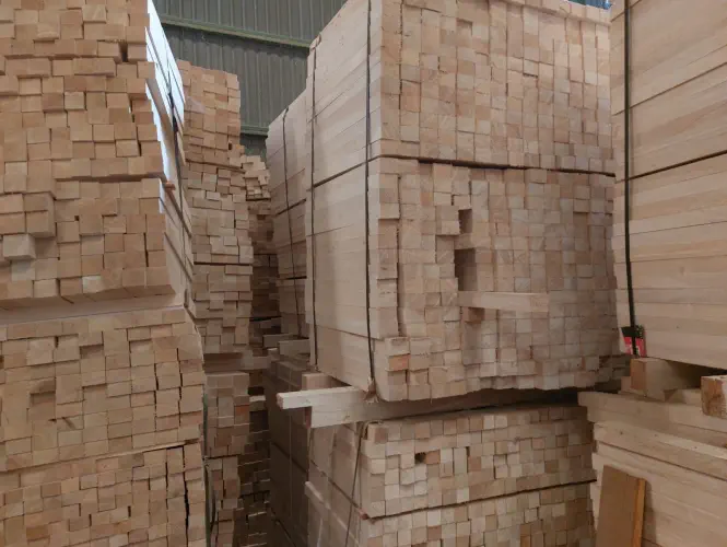 A photograph of stacks of balsa sawn tropical timber in a storage room