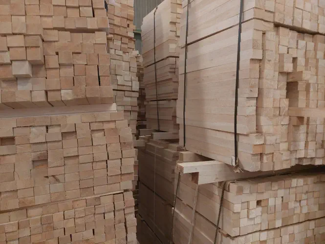 A photograph of stacks of balsa sawn tropical timber in a storage room