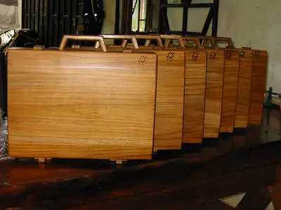 A photograph of briefcases with wooden hinges and closures